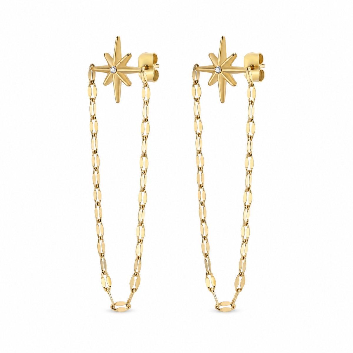 A pair of gold dangle earrings featuring a starburst stud with a small clear gemstone, connected by a long paperclip chain to matching starburst studs, shown on a plain white background.